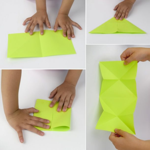 Le papier vert est plié en deux par de petites mains, un triangle, un diamant avant qu'il ne soit ouvert.