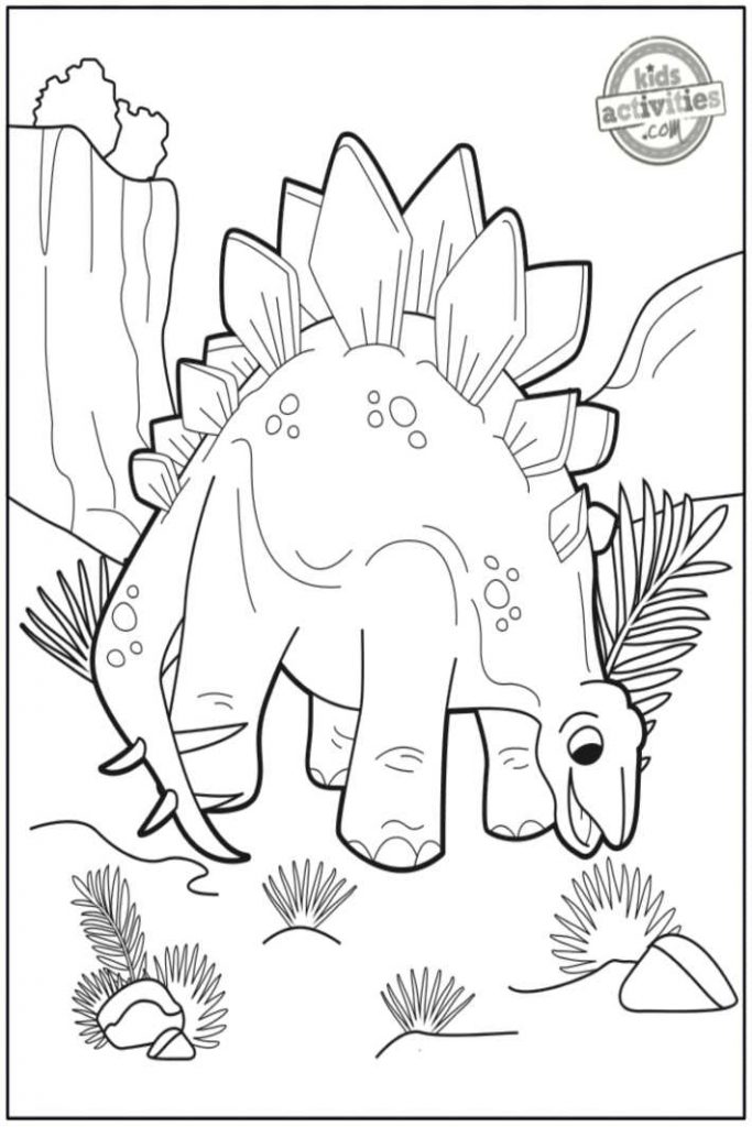 Coloriage stegosaurus imprimé pdf en noir et blanc montrant un dinosaure stegosaurus mangeant une brosse à côté d'une montagne - Kids Activities Blog