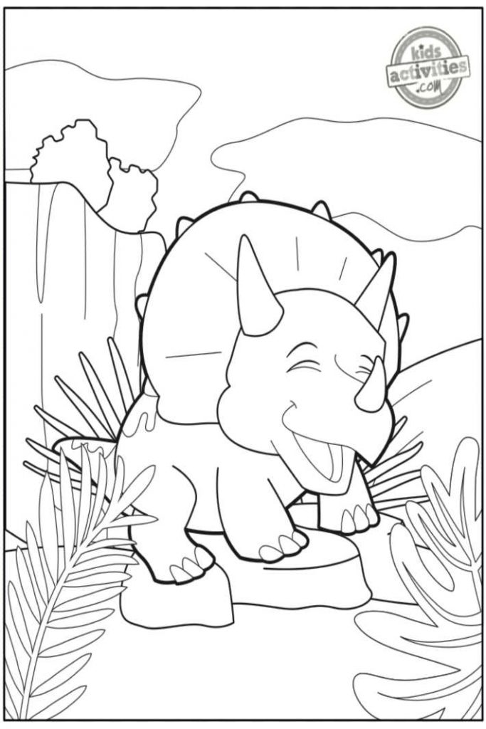 Page de coloriage bébé tricératops - pdf imprimé en noir et blanc de la page de coloriage bébé dinosaure montrant un bébé tricératops jouant sur un rocher à côté de gros rochers et d'arbustes tropicaux - Blog d'activités pour enfants