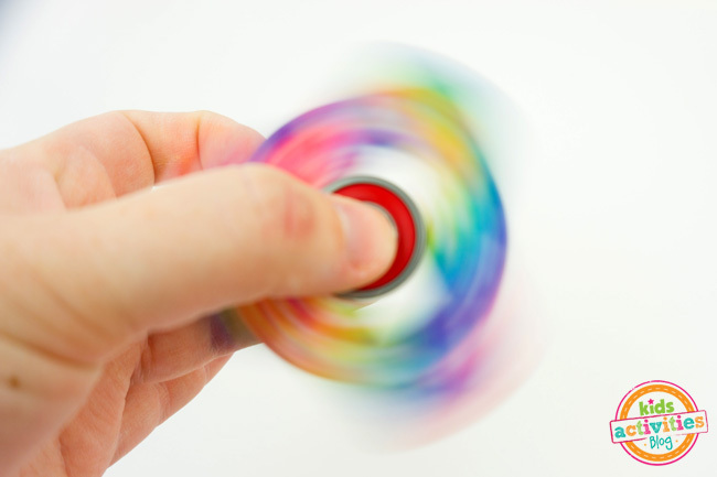 Comment faire des Fidget Spinners - image finale de l'artisanat de fidget spinner en action tournant avec des couleurs arc-en-ciel - Blog d'activités pour enfants