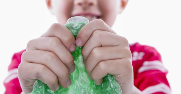 Garçon faisant du bruit pour le réveillon du Nouvel An avec du papier bulle coloré - activités du réveillon du Nouvel An - blog d'activités pour enfants