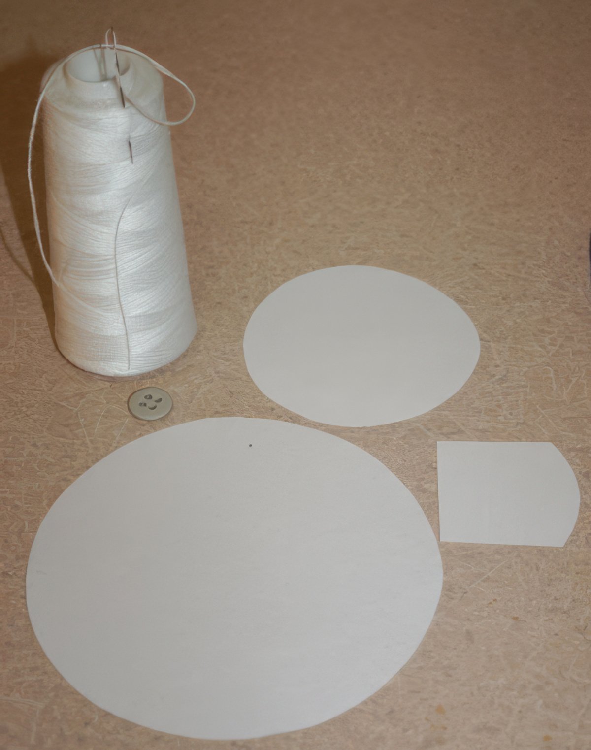 pièces dont vous avez besoin pour fabriquer une roue de lecture : ficelle, aiguille, bouton, papier
