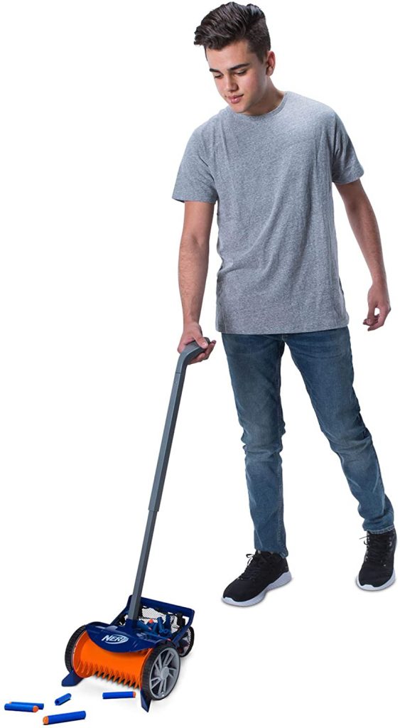 Ce garçon en jean et chemise grise utilise l'aspirateur nerf pour nettoyer ses fléchettes nerf Elite.